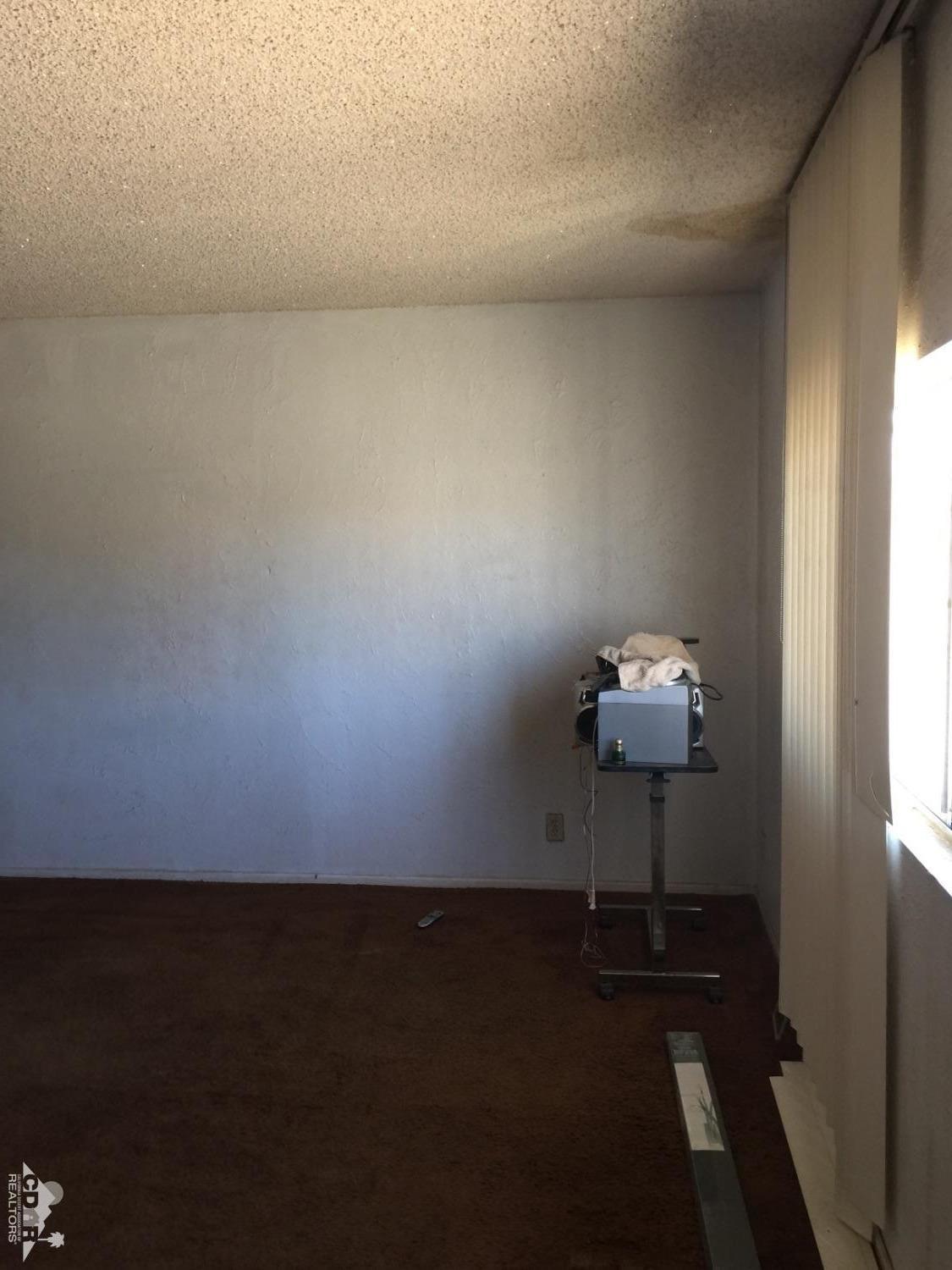 46751 Arabia Street Indio, CA 92201 - Photo 37 of 42 a room with a table and a chair