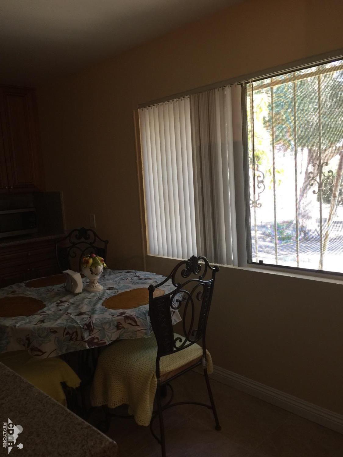 46751 Arabia Street Indio, CA 92201 - Photo 4 of 42 a bed sitting in a bedroom next to a window