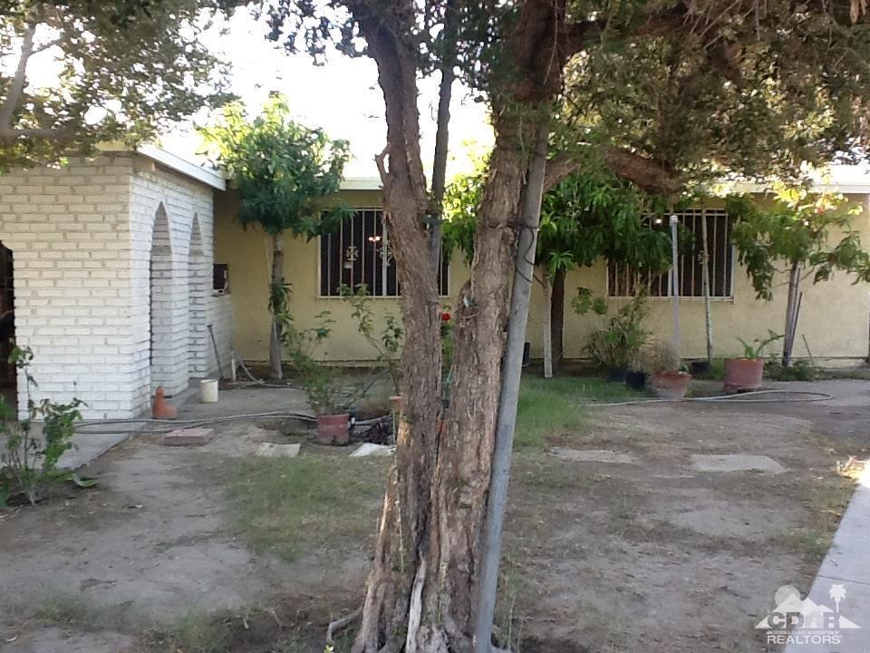 46751 Arabia Street Indio, CA 92201 - Photo 6 of 42 a view of a house with a tree in the background