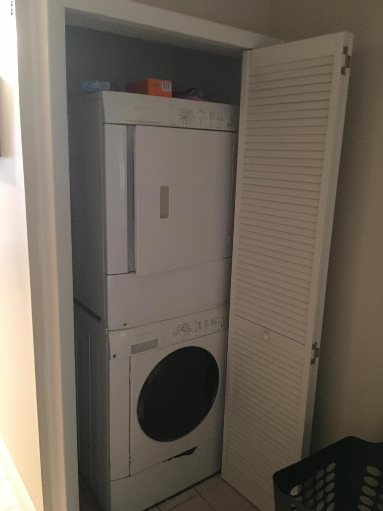 5500 Ocean Shore Boulevard, Unit 52 Ormond Beach, FL 32176 - Photo 11 of 33 a utility room with dryer and washer