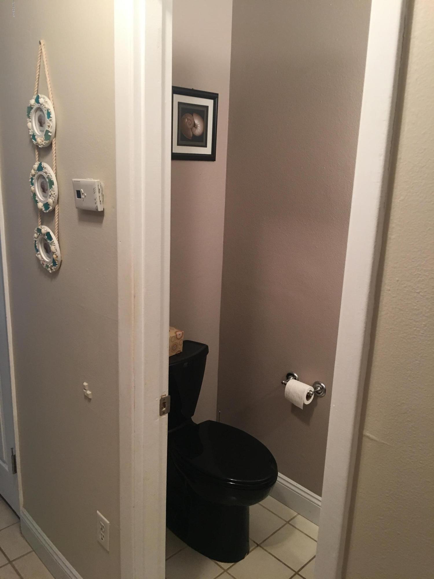 5500 Ocean Shore Boulevard, Unit 52 Ormond Beach, FL 32176 - Photo 12 of 33 a bathroom with a toilet and a sink