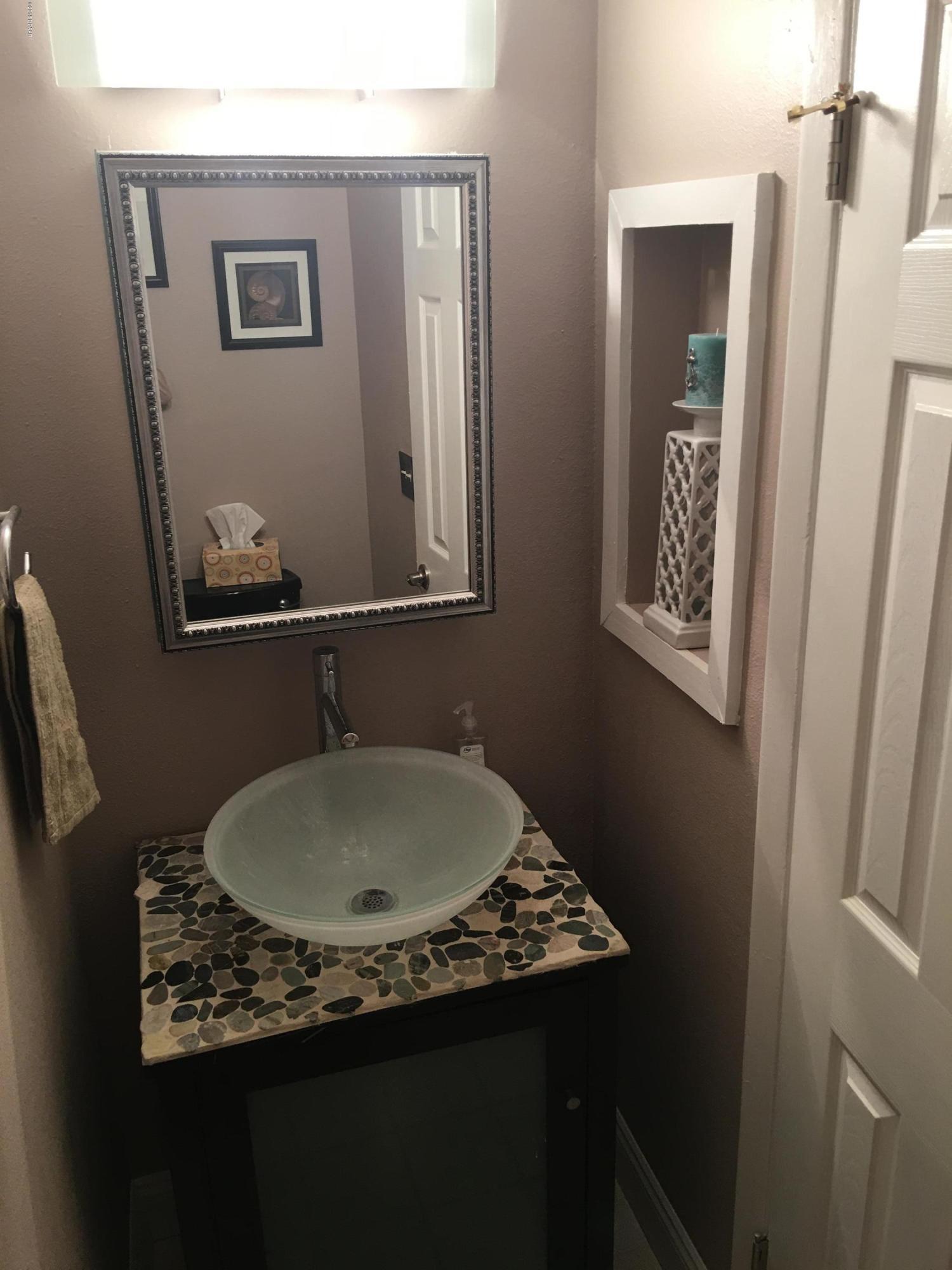 5500 Ocean Shore Boulevard, Unit 52 Ormond Beach, FL 32176 - Photo 13 of 33 a bathroom with a granite countertop sink and a mirror