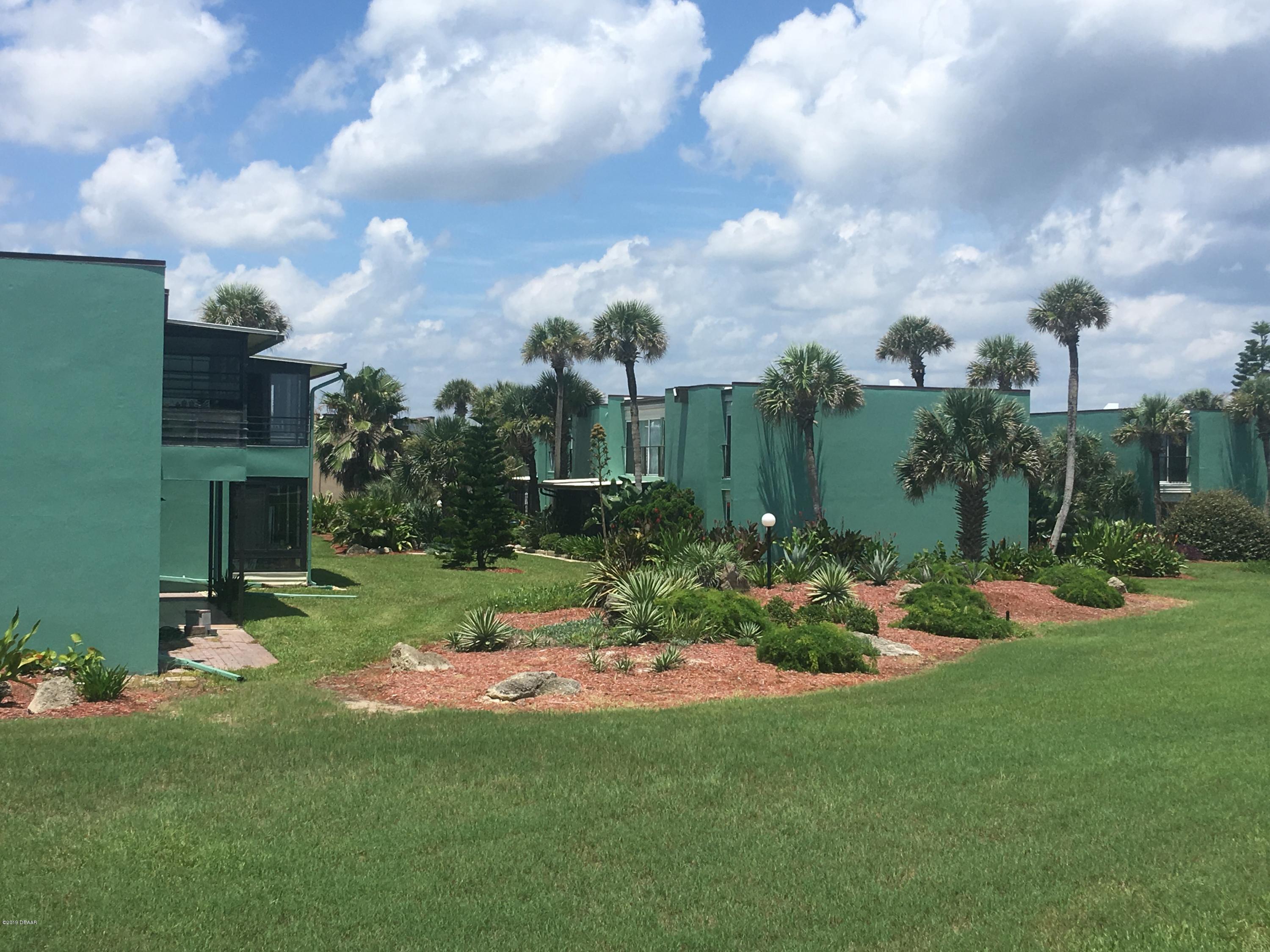 5500 Ocean Shore Boulevard, Unit 52 Ormond Beach, FL 32176 - Photo 2 of 33 a view of a table and chairs in the garden