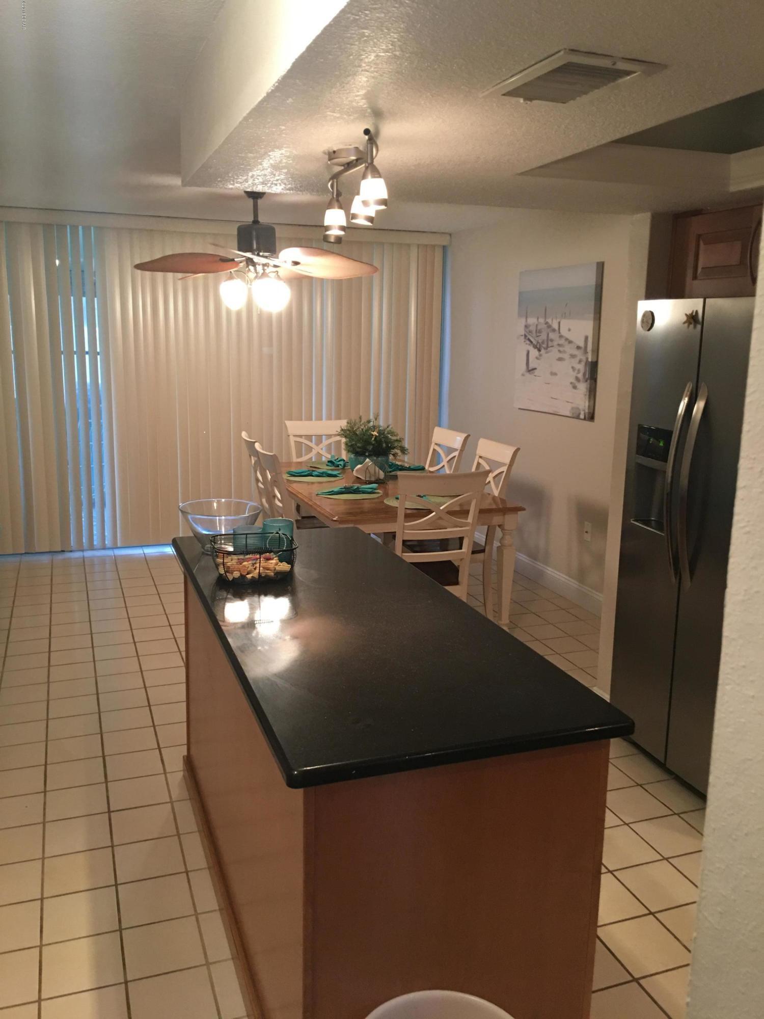 5500 Ocean Shore Boulevard, Unit 52 Ormond Beach, FL 32176 - Photo 7 of 33 a view of kitchen with granite countertop window