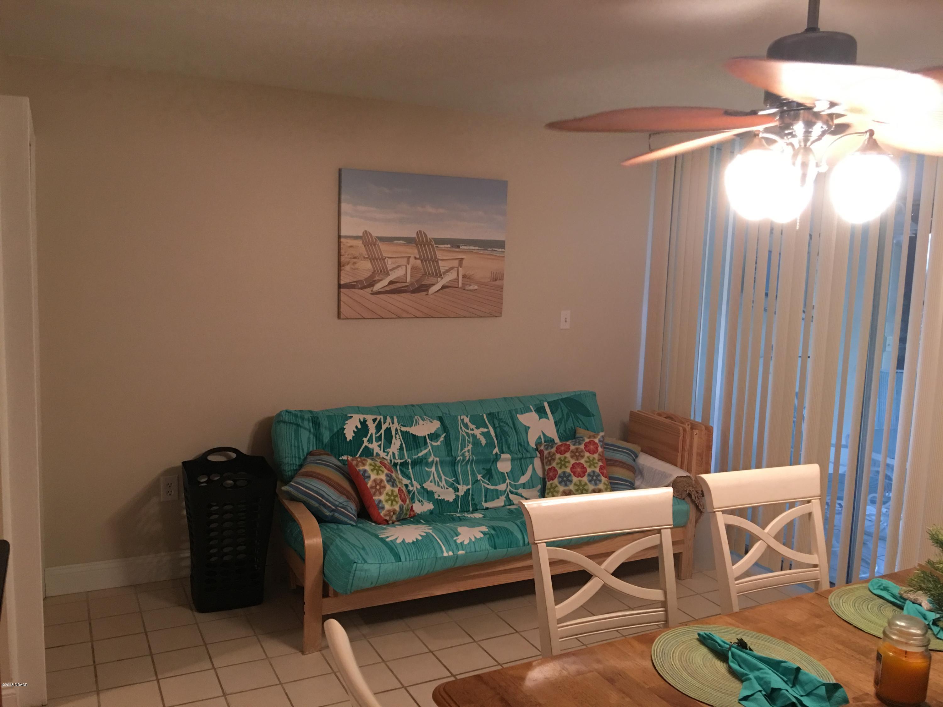 5500 Ocean Shore Boulevard, Unit 52 Ormond Beach, FL 32176 - Photo 9 of 33 a balcony with chairs and a table