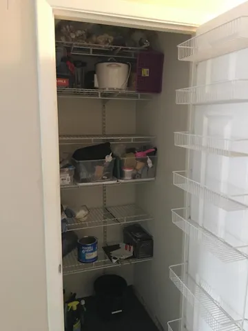 a close view of water heater and wooden cabinets