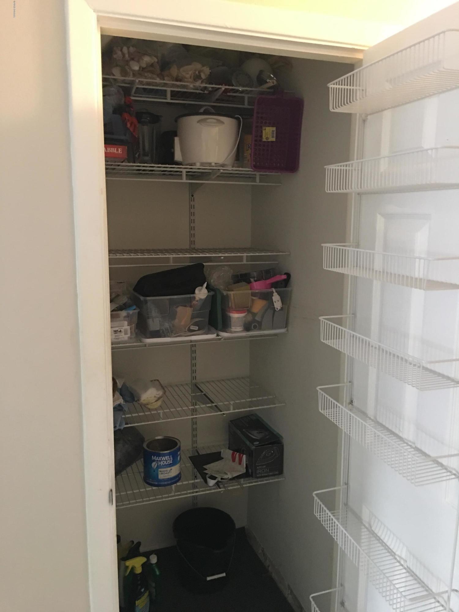 5500 Ocean Shore Boulevard, Unit 52 Ormond Beach, FL 32176 - Photo 10 of 33 a close view of water heater and wooden cabinets