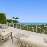 a view of a terrace with furniture and a garden