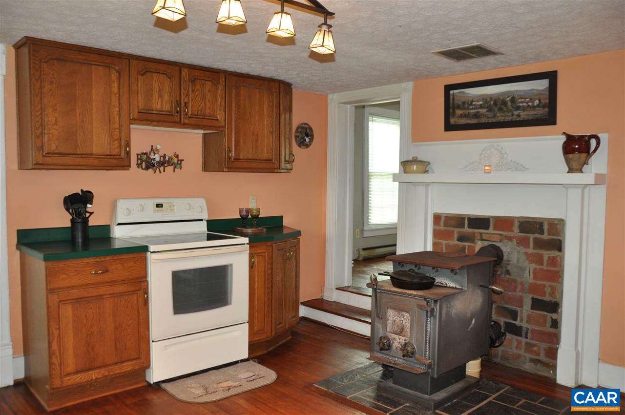 121 Turkey Mountain Road Amherst, VA 24521 - Photo 14 of 40 a kitchen with a stove and a fireplace