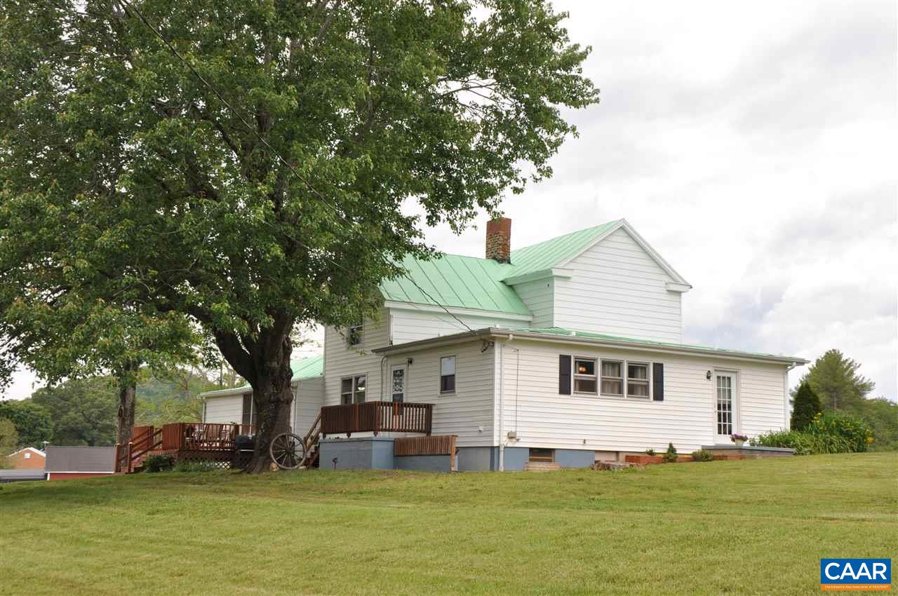 121 Turkey Mountain Road Amherst, VA 24521 - Photo 3 of 40 a view of a white house with a big yard plants and large trees