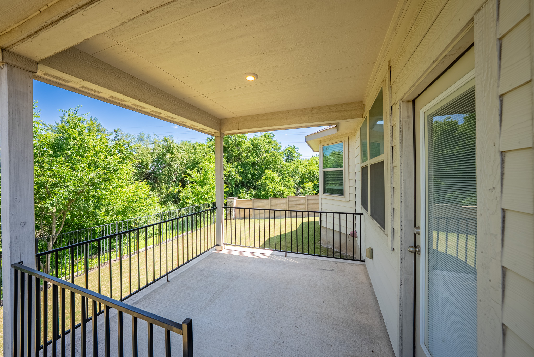 2508 Hat Bender Loop Round Rock, TX 78664 - Photo 20 of 22 Covered outdoor patio featuring a concrete floor, black metal railing, and recessed lighting