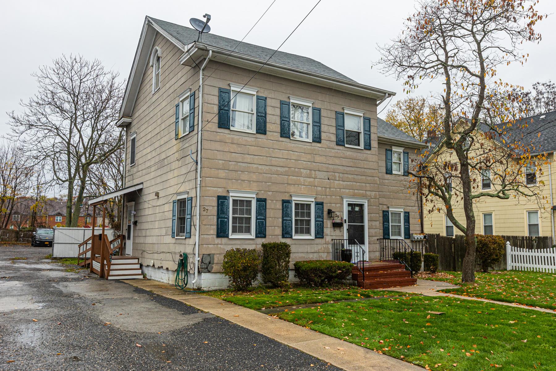 27 James Street Babylon, NY 11702 - Photo 1 of 1 View of front of property featuring a shingled roof, a front yard, and fence