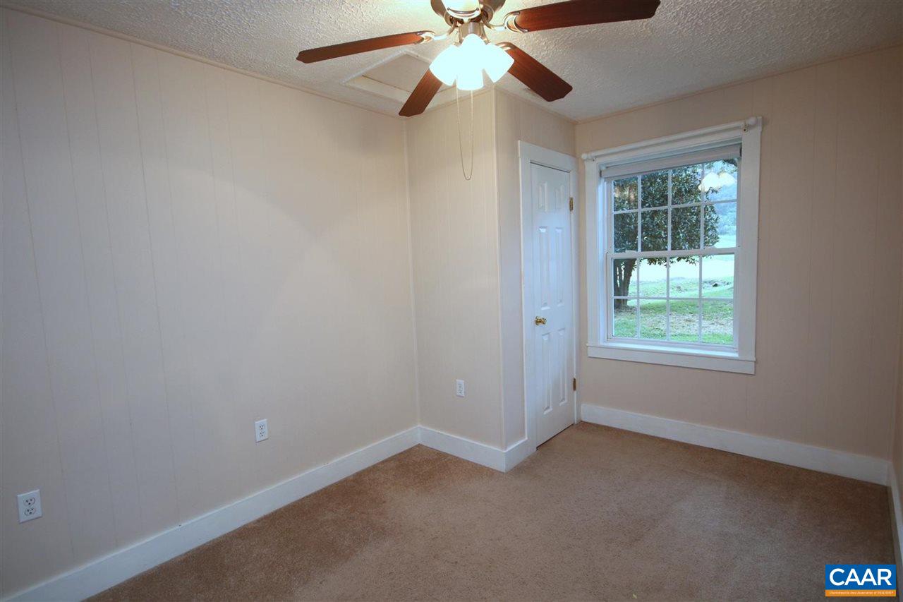 6773 Orange Road Orange, VA 22960 - Photo 16 of 31 an empty room with a window and a fan