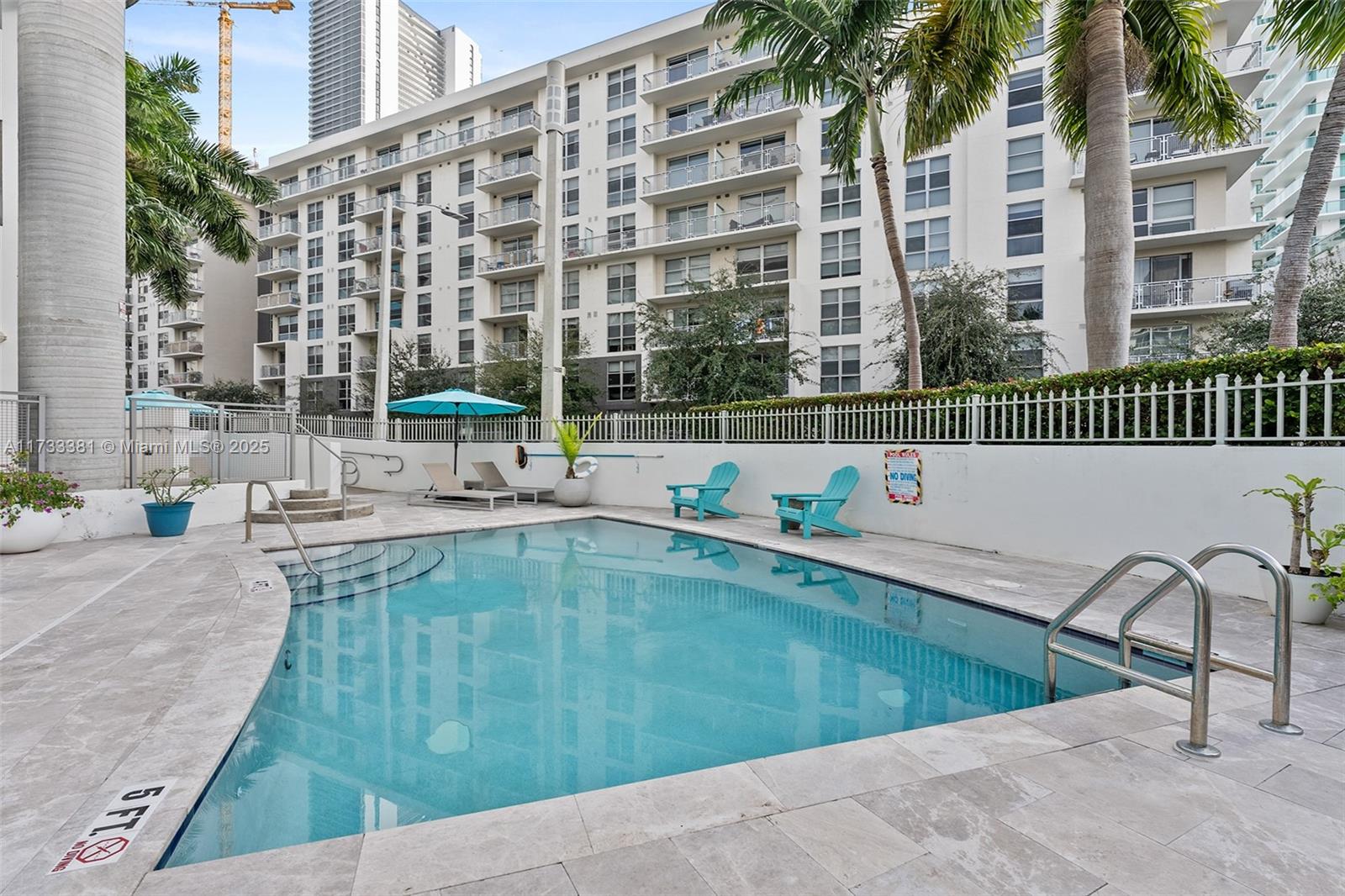 455 Northeast 25th Street, Unit 509 Miami, FL 33137 - Photo 22 of 30 a swimming pool with outdoor seating and yard