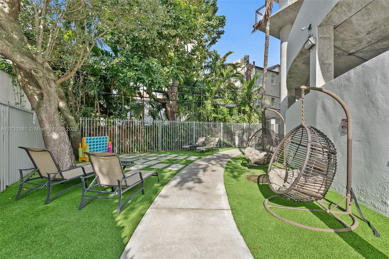 455 Northeast 25th Street, Unit 509 Miami, FL 33137 - Photo 24 of 30 a view of a chair and table in backyard