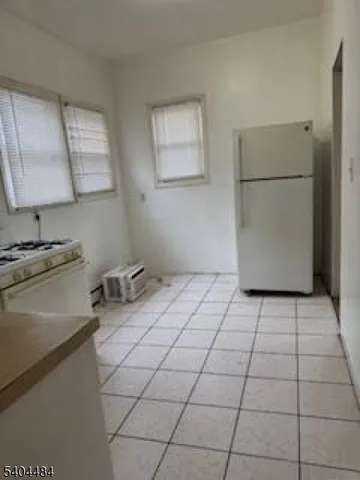 a kitchen with a stove a refrigerator and a sink