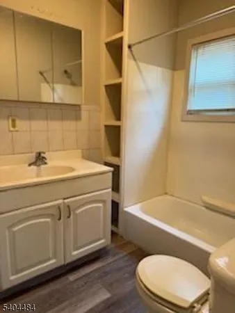 a bathroom with a sink a toilet and bathtub