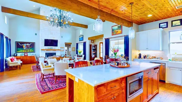 a view of kitchen filled with furniture and flat screen tv