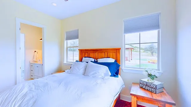 a bedroom with a bed and a window