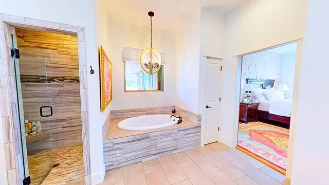 a bathroom with a tub a sink and a window