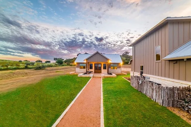 a view of a house with swimming pool and a yard