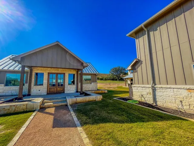 a swimming pool with outdoor seating and yard