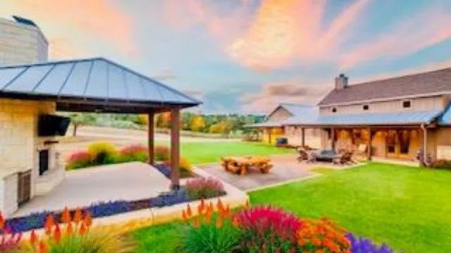 a view of a house with garden and patio
