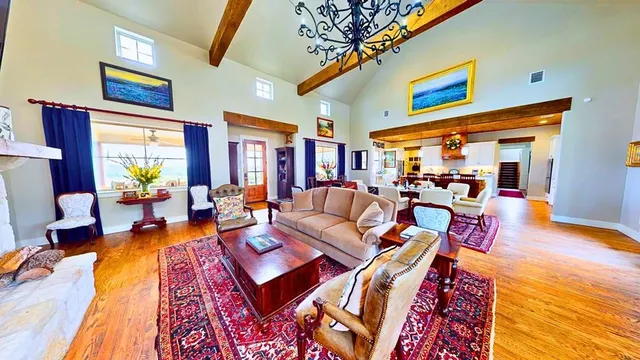 a living room with furniture fireplace and a table