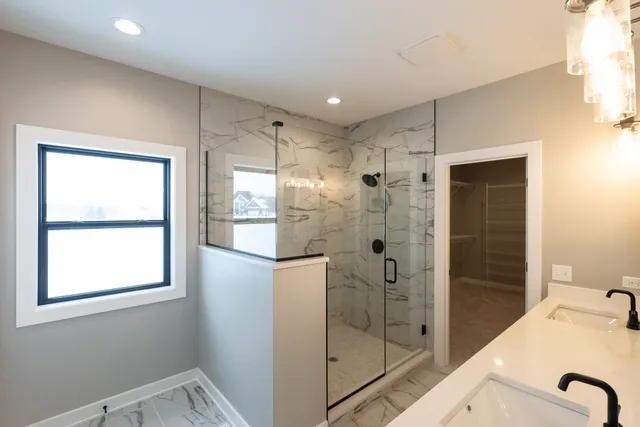 a bathroom with a shower and a sink