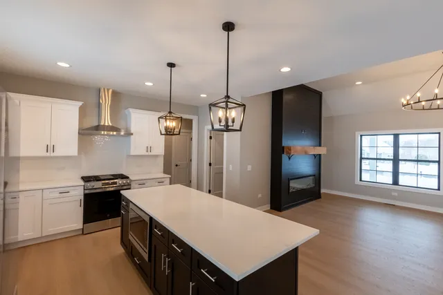 a kitchen with kitchen island a sink stainless steel appliances and window