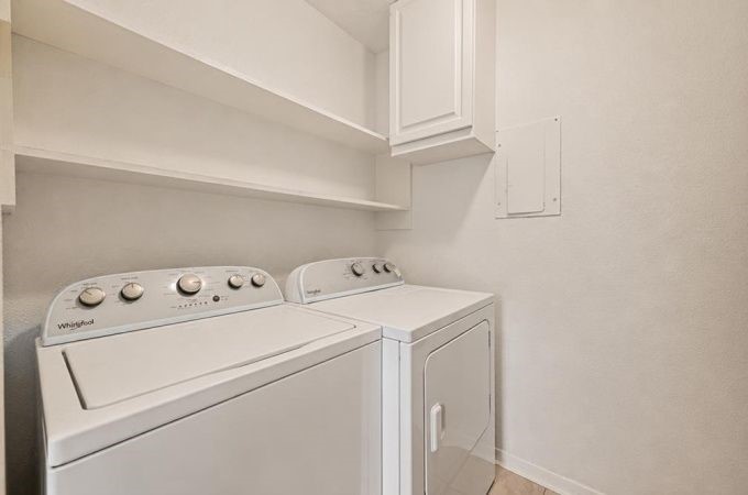 6404 Burgoyne Road, Unit 159 Houston, TX 77057 - Photo 14 of 38 Efficient laundry room featuring modern appliances, ample shelving, and sleek cabinetry for convenient storage and organization