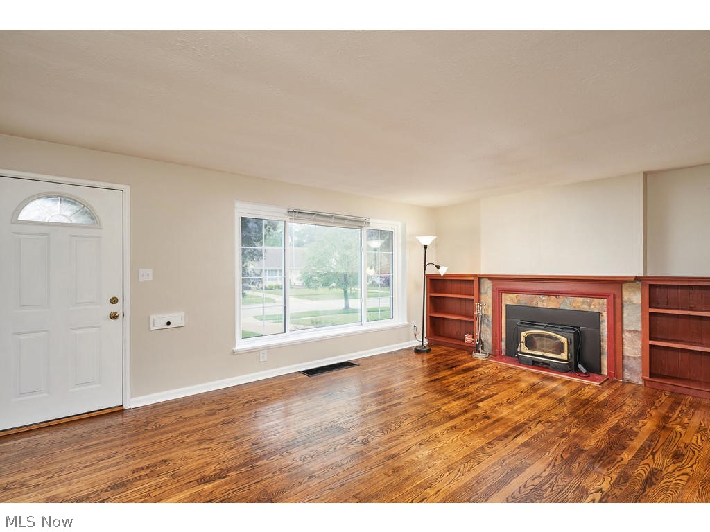 16474 Webster Road Cleveland, OH 44130 - Photo 6 of 21 Living Room w/wood burner, built-ins and hardwood floors