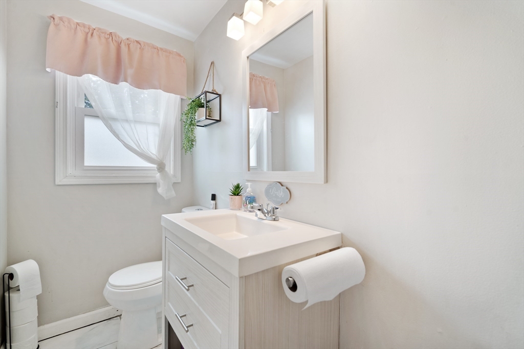71 Price Street Springfield, MA 01104 - Photo 11 of 42 a bathroom with a sink toilet and mirror