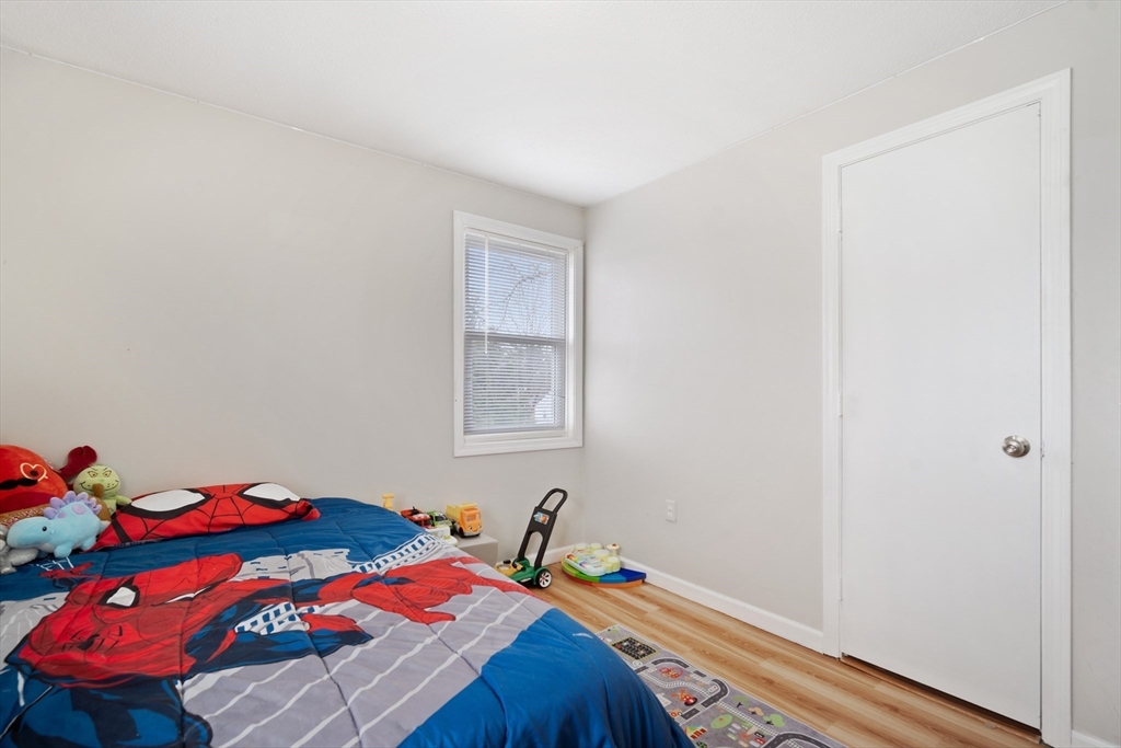 71 Price Street Springfield, MA 01104 - Photo 14 of 42 a bedroom with a bed and a window