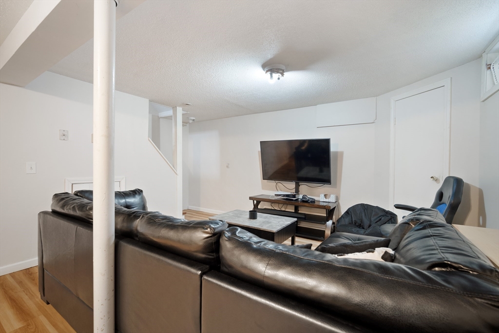 71 Price Street Springfield, MA 01104 - Photo 19 of 42 a bedroom with a bed and a flat screen tv