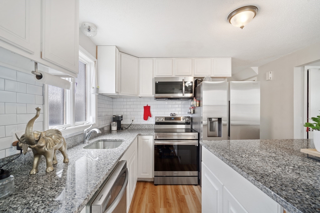 71 Price Street Springfield, MA 01104 - Photo 23 of 42 a kitchen with granite countertop a sink stainless steel appliances and counter space