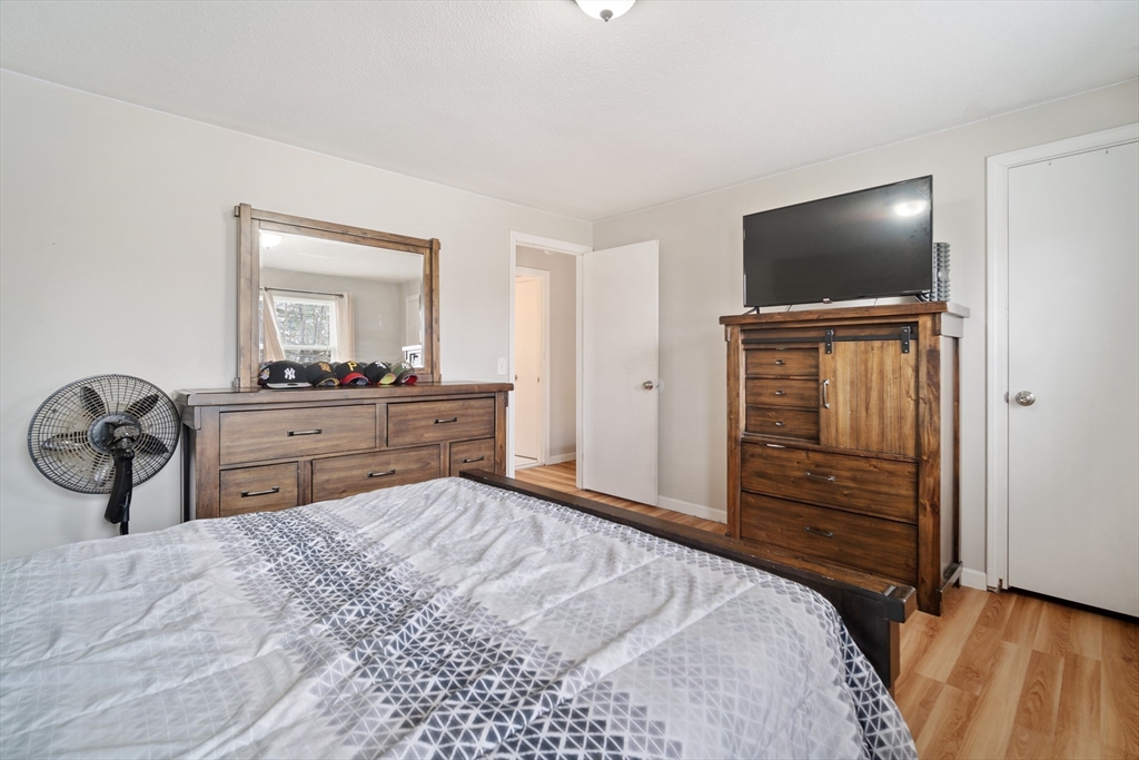 71 Price Street Springfield, MA 01104 - Photo 30 of 42 a bedroom with a bed and a flat screen tv