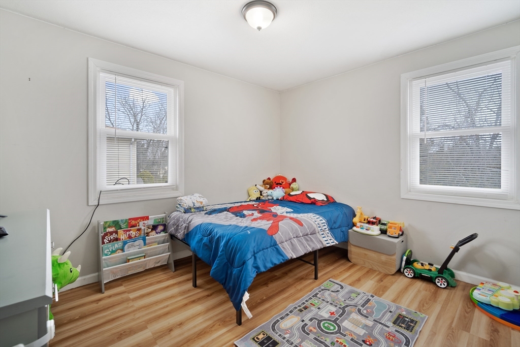 71 Price Street Springfield, MA 01104 - Photo 31 of 42 a bedroom with a bed and wooden floor