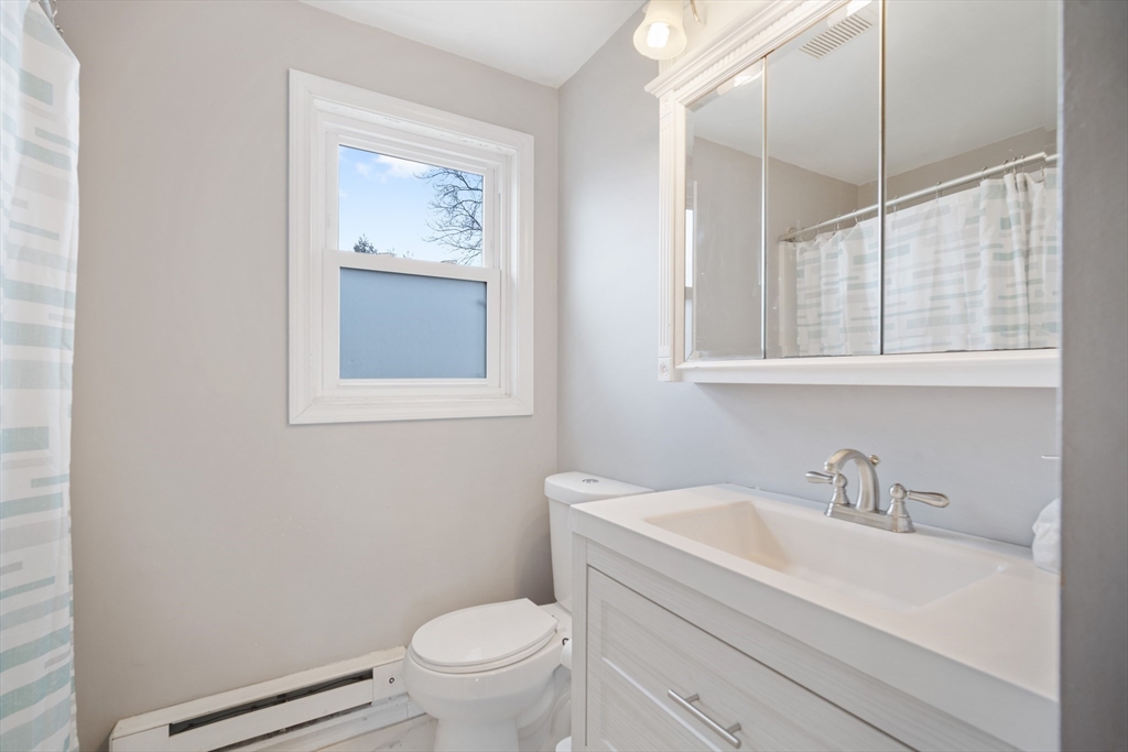 71 Price Street Springfield, MA 01104 - Photo 32 of 42 a bathroom with a sink toilet and a window