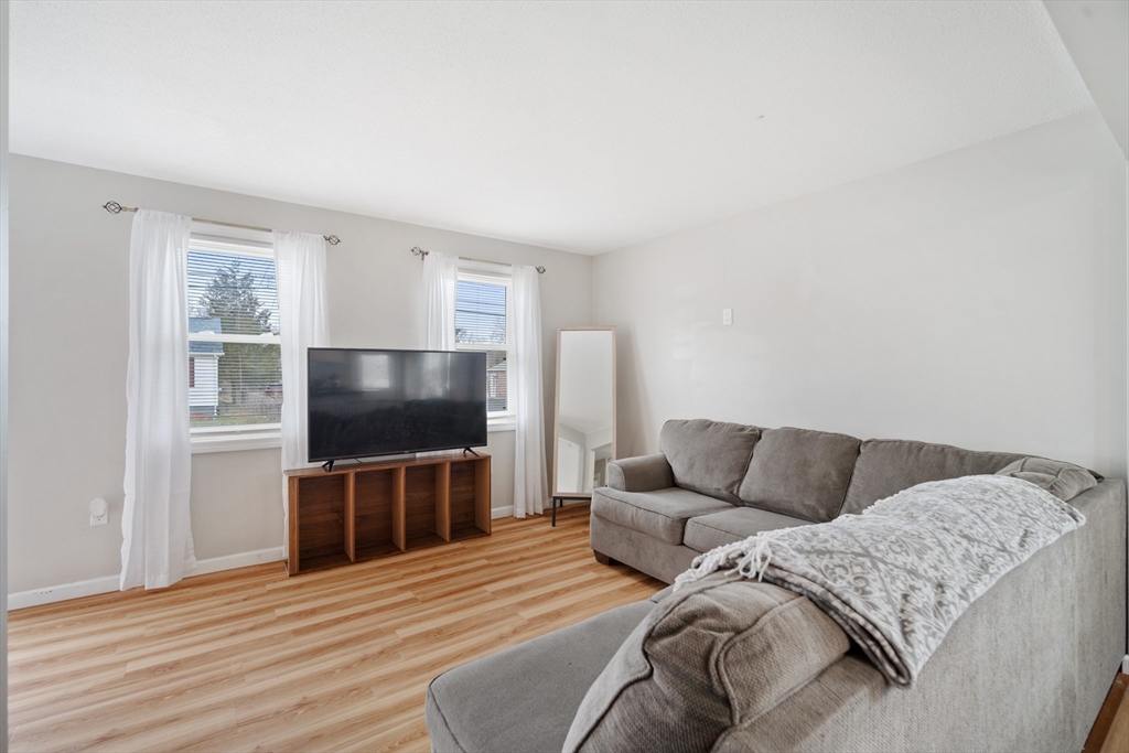 71 Price Street Springfield, MA 01104 - Photo 5 of 42 a living room with a couch and a flat screen tv