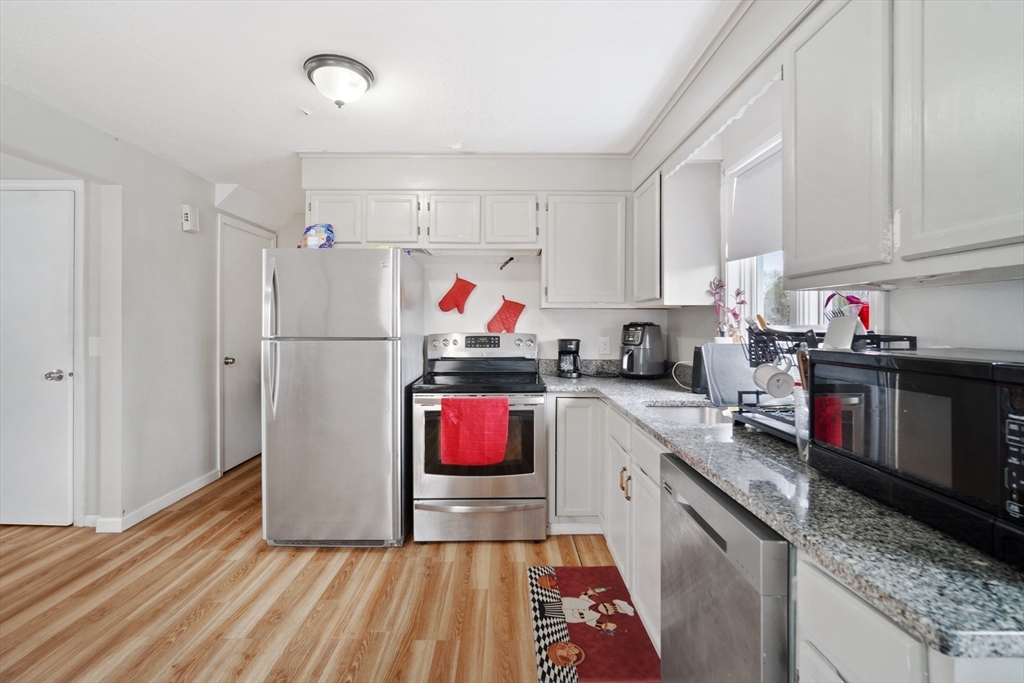 71 Price Street Springfield, MA 01104 - Photo 9 of 42 a kitchen with refrigerator and microwave