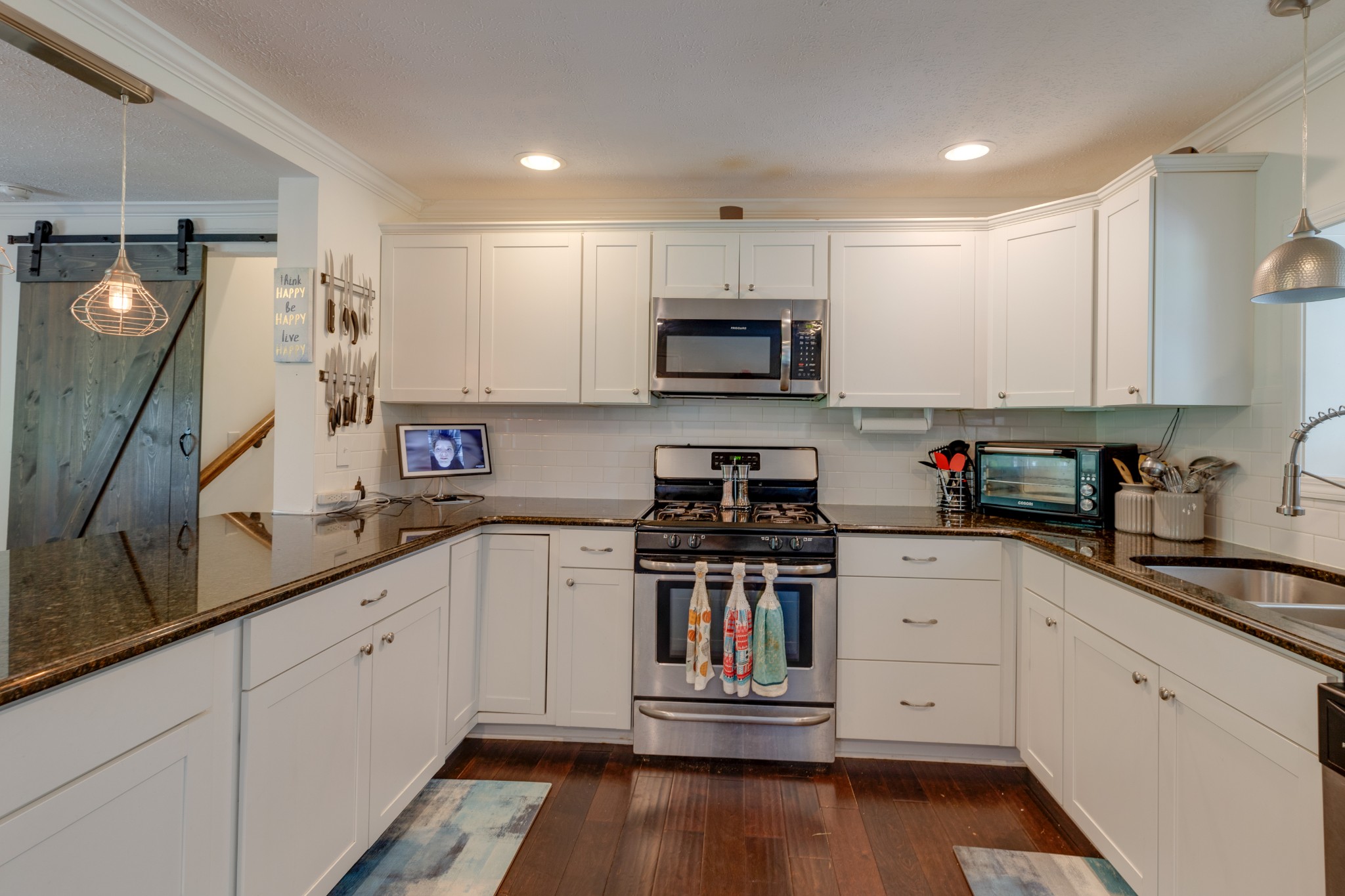 1765 Hayshed Road Charlotte, TN 37036 - Photo 13 of 34 a kitchen with kitchen island granite countertop a sink and steel appliances