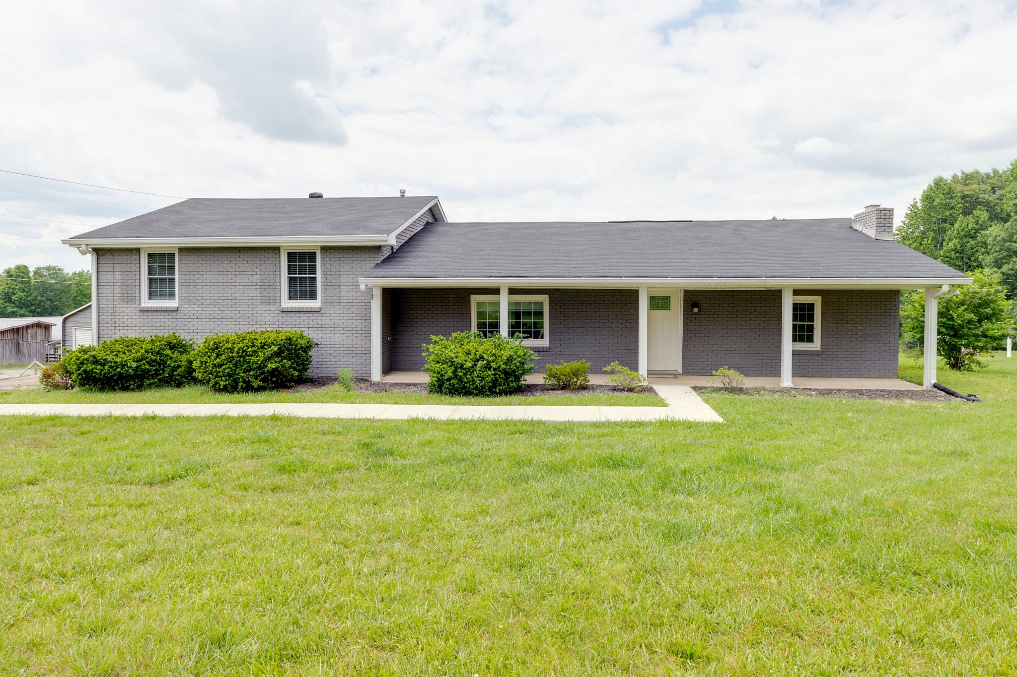 1765 Hayshed Road Charlotte, TN 37036 - Photo 2 of 34 a front view of a house with a yard