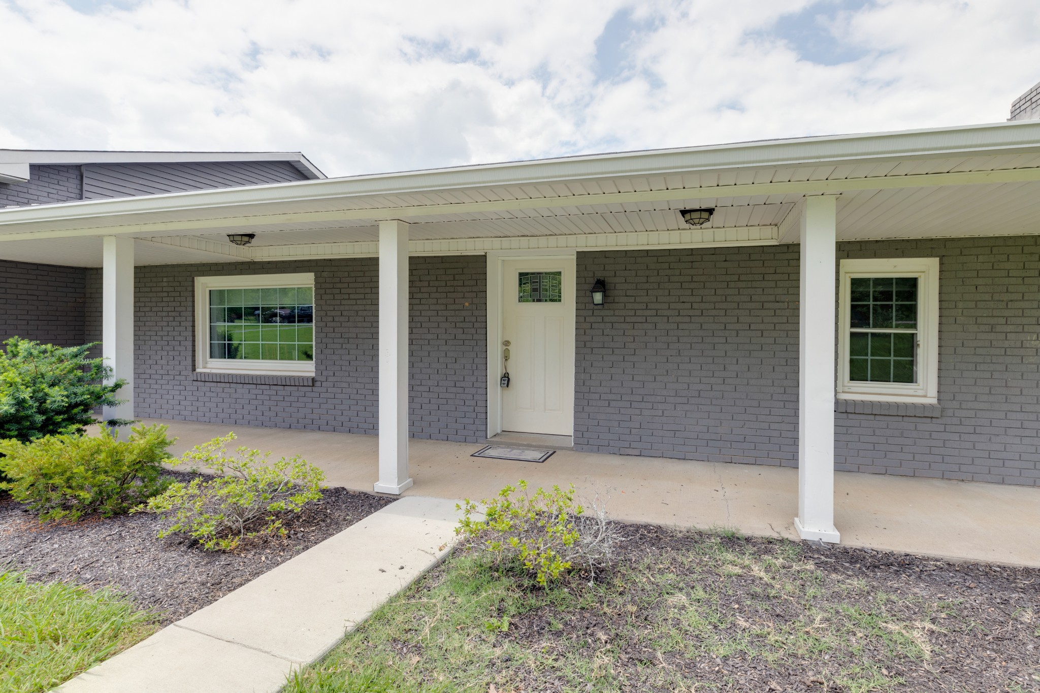 1765 Hayshed Road Charlotte, TN 37036 - Photo 3 of 34 a front view of a house with garden