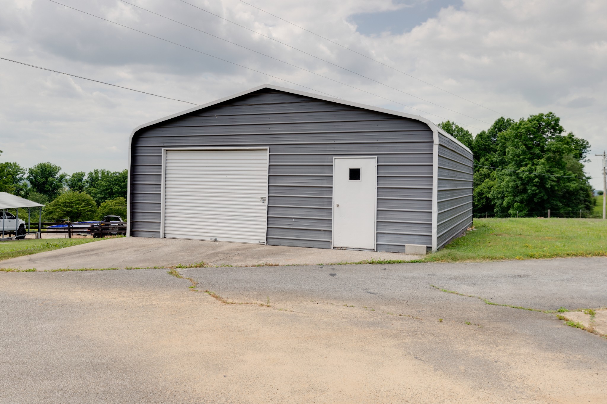 1765 Hayshed Road Charlotte, TN 37036 - Photo 33 of 34 a front view of a house with a yard and garage