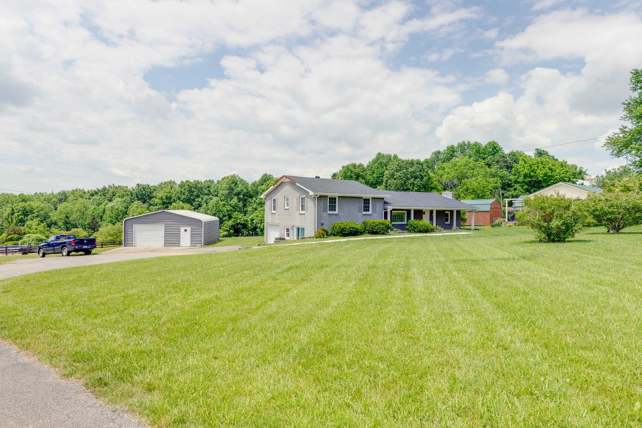 1765 Hayshed Road Charlotte, TN 37036 - Photo 4 of 34 a front view of a house with a yard and trees