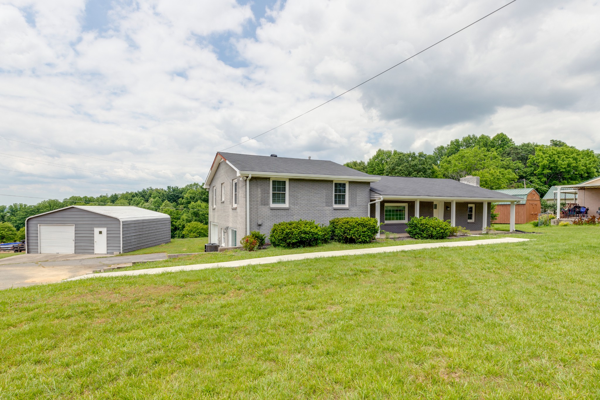 1765 Hayshed Road Charlotte, TN 37036 - Photo 5 of 34 a view of a house with a big yard and potted plants
