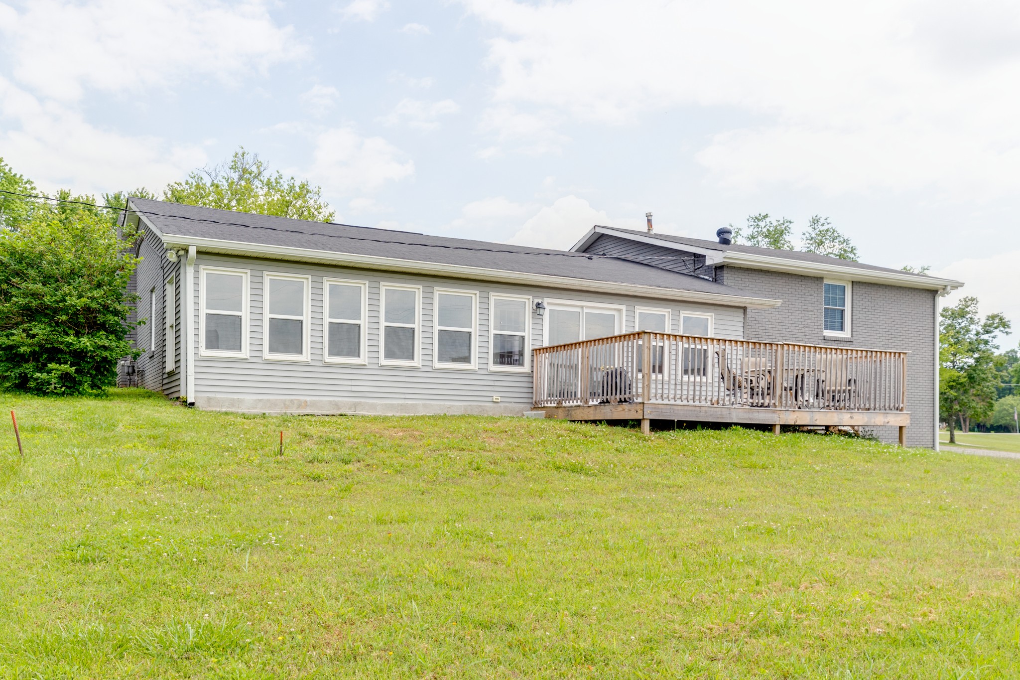 1765 Hayshed Road Charlotte, TN 37036 - Photo 7 of 34 a view of a house with a garden and deck