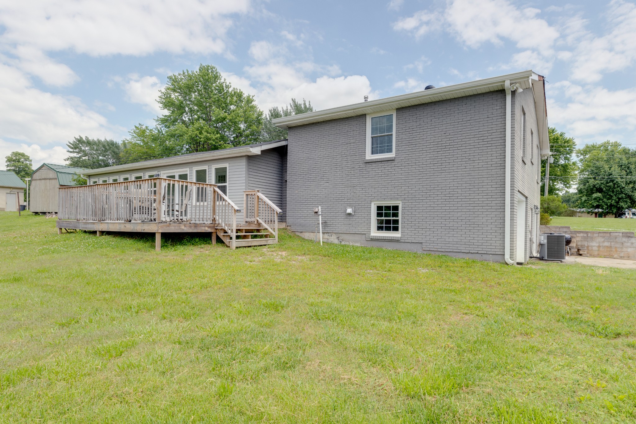 1765 Hayshed Road Charlotte, TN 37036 - Photo 8 of 34 a backyard of a house with wooden deck and barbeque oven