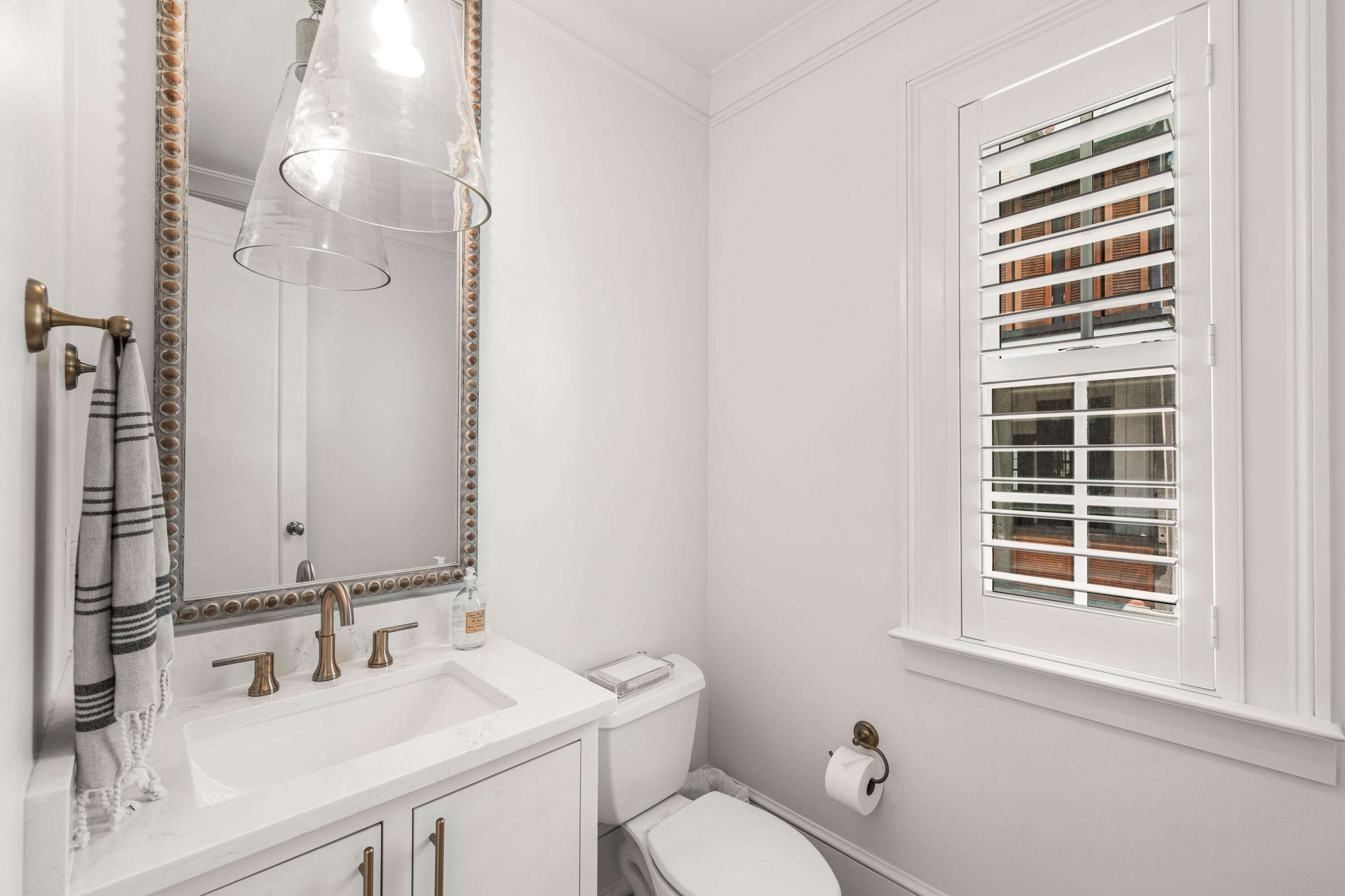 249 Lifeguard Loop East, Unit A3 Inlet Beach, FL 32461 - Photo 32 of 60 a bathroom with a sink a toilet and a mirror